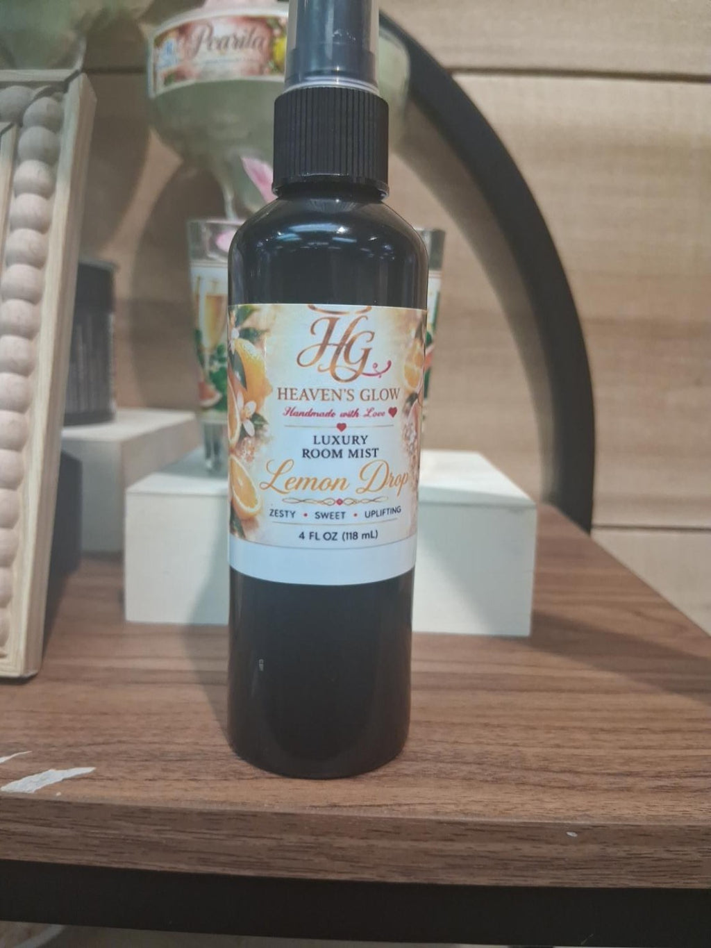 Heaven’s Glow Lemon Drop Luxury Room Mist 4 fl oz black spray bottle showing the citrus-themed front label
